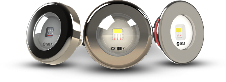 Três modelos de refletores LED Tholz com acabamentos diferentes, alinhados lado a lado.